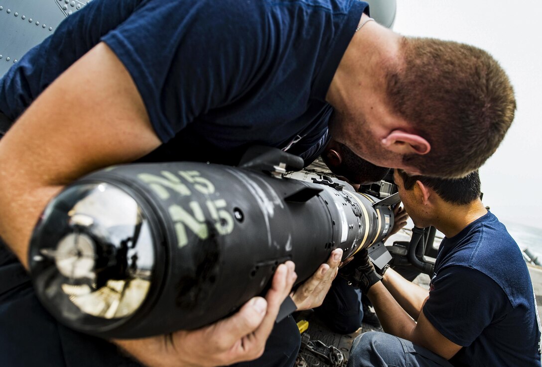 Sailors load an AGM-114 Hellfire missile onto an MH-60R Seahawk helicopter on the USS San Jacinto in the Strait of Bab-el-Mandeb, July 12, 2016. The helicopter is assigned to Helicopter Maritime Strike Squadron 74. The guided-missile cruiser is supporting maritime security operations and theater security cooperation efforts in the U.S. 5th Fleet area of operations. Navy photo by Petty Officer 3rd Class J. Alexander Delgado