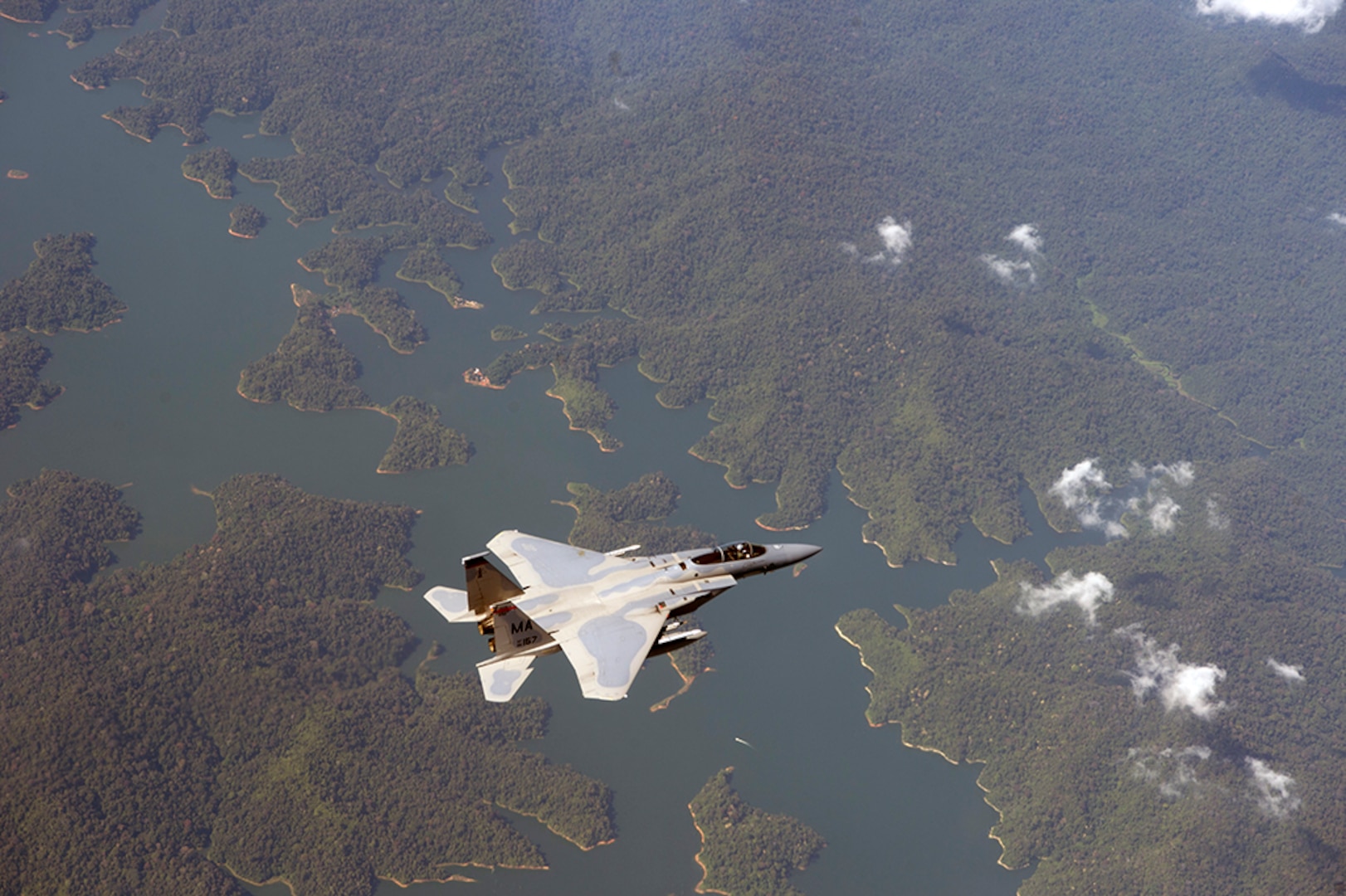 In this photo file, a U.S. Air Force F-15 Eagle from the 131st Fighter Squadron, 104th Fighter Wing, Barnes Air National Guard Base, Mass., flies over Penang, Malaysia, during Cope Taufan 14, June 18, 2014. Cope Taufan is a biennial large force employment exercise taking place June 9 to 20 designed to improve U.S. and Malaysian combined readiness. 