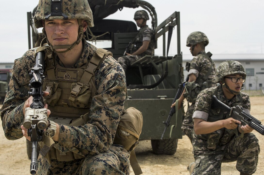 Marine Corps Cpl. Beau M. Higgins posts security beside a South Korean marine during convoy escort training as part of Korean Marine Exchange Program 16-11 in South Korea, July 11, 2016. The program offers realistic training, leveraging the most advanced tactics and technology to ensure a trained and ready U.S.-South Korean force. Marine Corps photo by Lance Cpl. Amaia Unanue