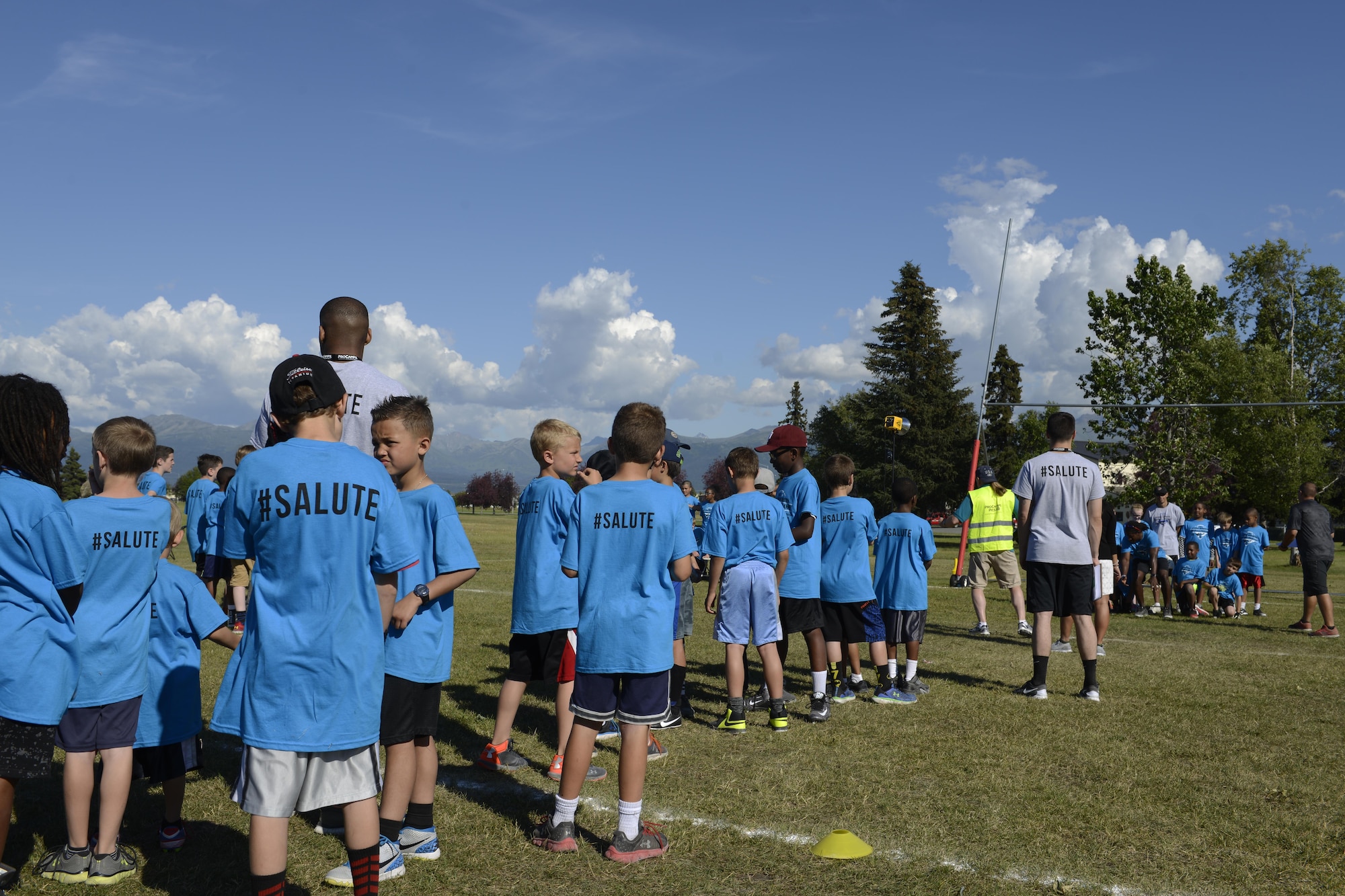 Military ProCamp participants anxiously await to have a their picture taken with Andre Roberts, a wide receiver with the Detroit Lions, at Joint Base Elmendorf-Richardson, Alaska, June 12, 2016. Roberts played college football at The Citadel, the Military College of South Carolina, before being drafted by the Arizona Cardinals in 2010. (U.S. Air Force photo by Airman 1st Class Javier Alvarez)