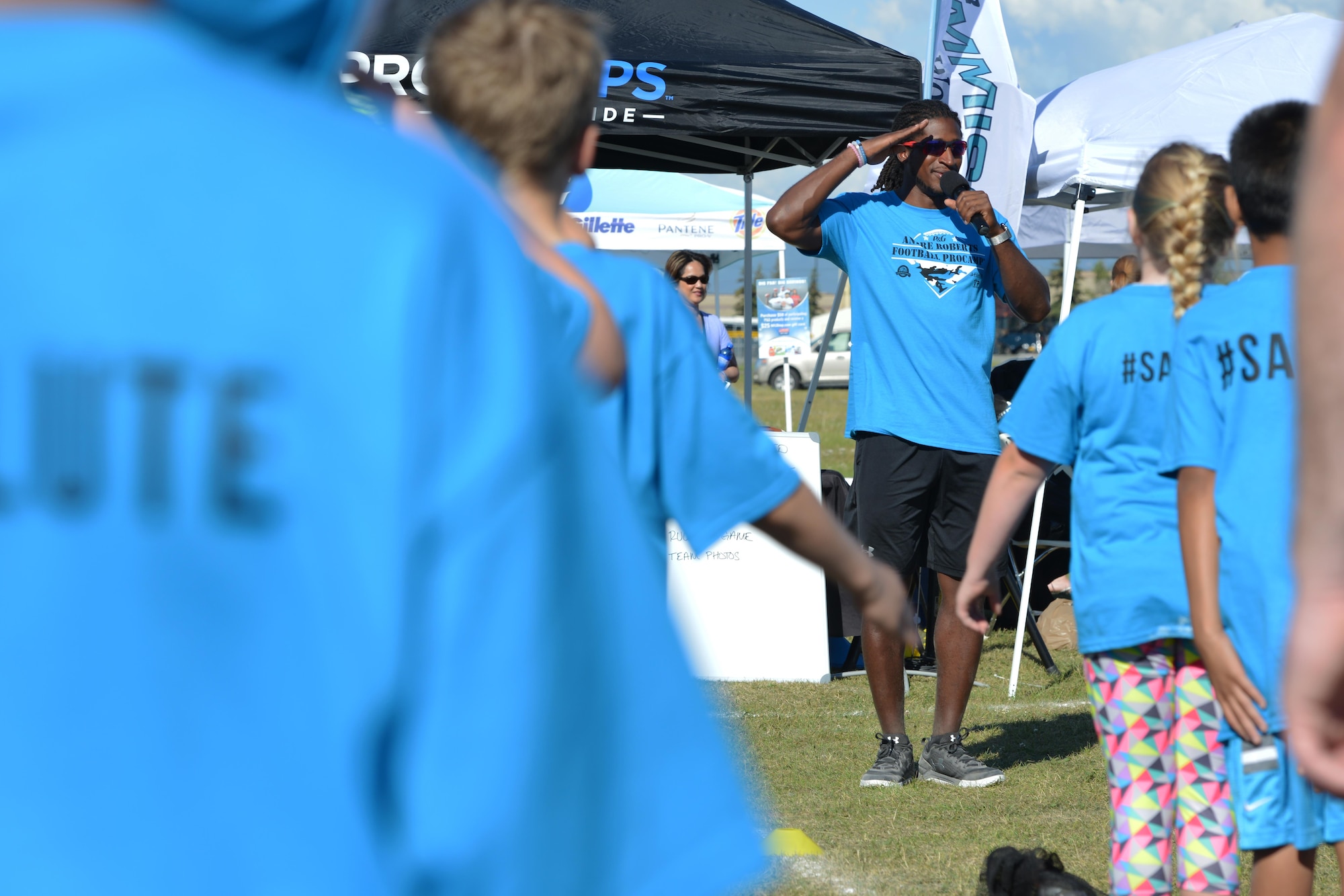 Andre Roberts, a wide receiver with the Detroit Lions, teaches the Andre Roberts Salute, a touchdown celebration dance, to Joint Base Elmendorf-Richardson athletes, at the Military ProCamp, at Joint Base Elmendorf-Richardson, Alaska, June 12, 2016. Players performed the salute after every touchdown in the seven-on-seven game following practice. (U.S. Air Force photo by Airman 1st Class Javier Alvarez)