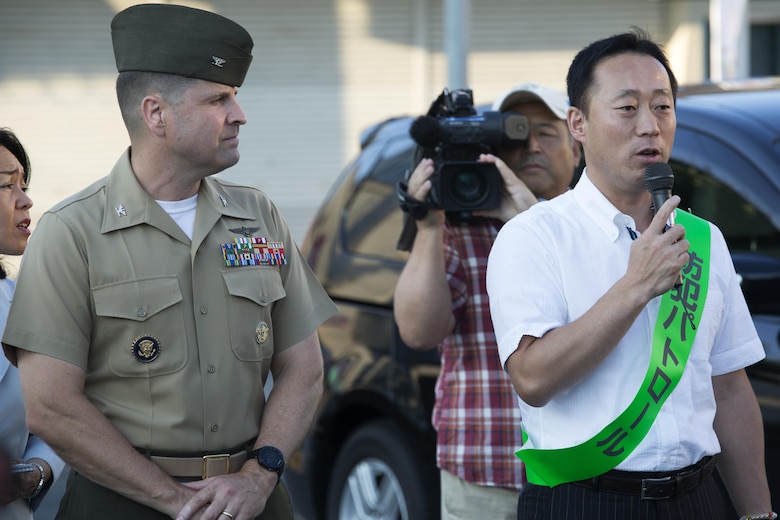 The Honorable Yoshihiko Fukuda, mayor of Iwakuni, Japan, right, and U.S. Marine Corps Col. Robert V. Boucher, commanding officer of Marine Corps Air Station Iwakuni, address a crowd and local Japanese media before participating in the seventh Joint Leadership Walk down the streets of Iwakuni on July 6, 2016. The last walk took place in December 2015 and continues to be a firm demonstration of the bond and unity between both communities. (U.S. Marine Corps photo by Lance Cpl. Donato Maffin/Released)