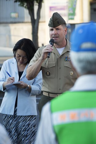 U.S. Marine Corps Col. Robert V. Boucher, commanding officer of Marine Corps Air Station Iwakuni, addresses a crowd and local Japanese media before participating in the seventh Joint Leadership Walk down the streets of Iwakuni on July 6, 2016. The last walk took place in December 2015 and continues to be a firm demonstration of the bond and unity between both communities. (U.S. Marine Corps photo by Lance Cpl. Donato Maffin/Released)