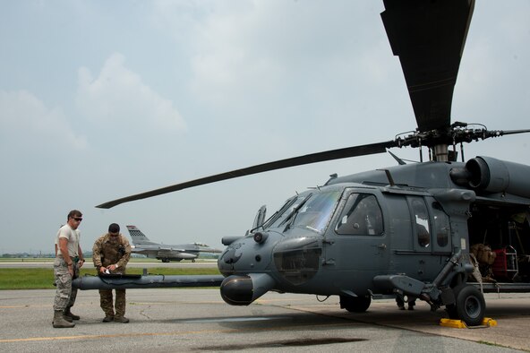 SSgt Brandon McCown, 33rd Helicopter Maintenance Unit crew chief, and Master Sgt. Vincent Hnat, 33rd Rescue Squadron special mission aviator, review a preflight checklist before flight during Exercise Pacific Thunder 16-2 at Osan Air Base, Republic of Korea, July 12, 2016. The 33rd RQS is participating in Pacific Thunder, the largest Air Force combined joint combat search and rescue exercise in the Pacific. (U.S. Air Force photo by Staff Sgt. Jonathan Steffen/Released) 