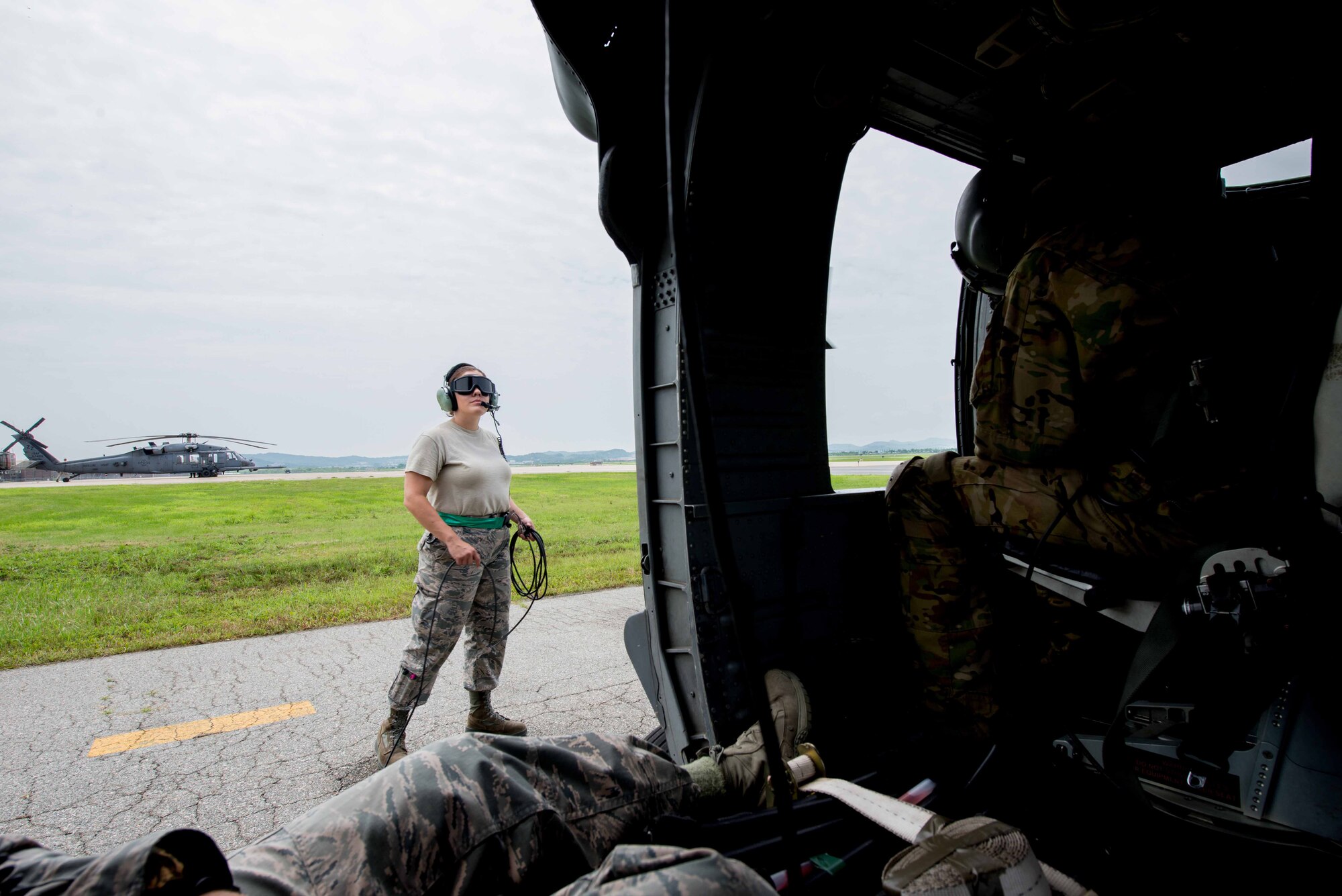 Senior Airman Gricelda Tomson, 33rd Helicopter Maintenance Unit guidance flight control technician, watches as an HH-60G Pave Hawk assigned to the 33rd Rescue Squadron starts up during Exercise Pacific Thunder 16-2 at Osan Air Base, Republic of Korea, July 13, 2016. The 33rd RQS comes to Osan to participate in Pacific Thunder to train their combat search and rescue capabilities. (U.S. Air Force photo by Staff Sgt. Jonathan Steffen/Released) 