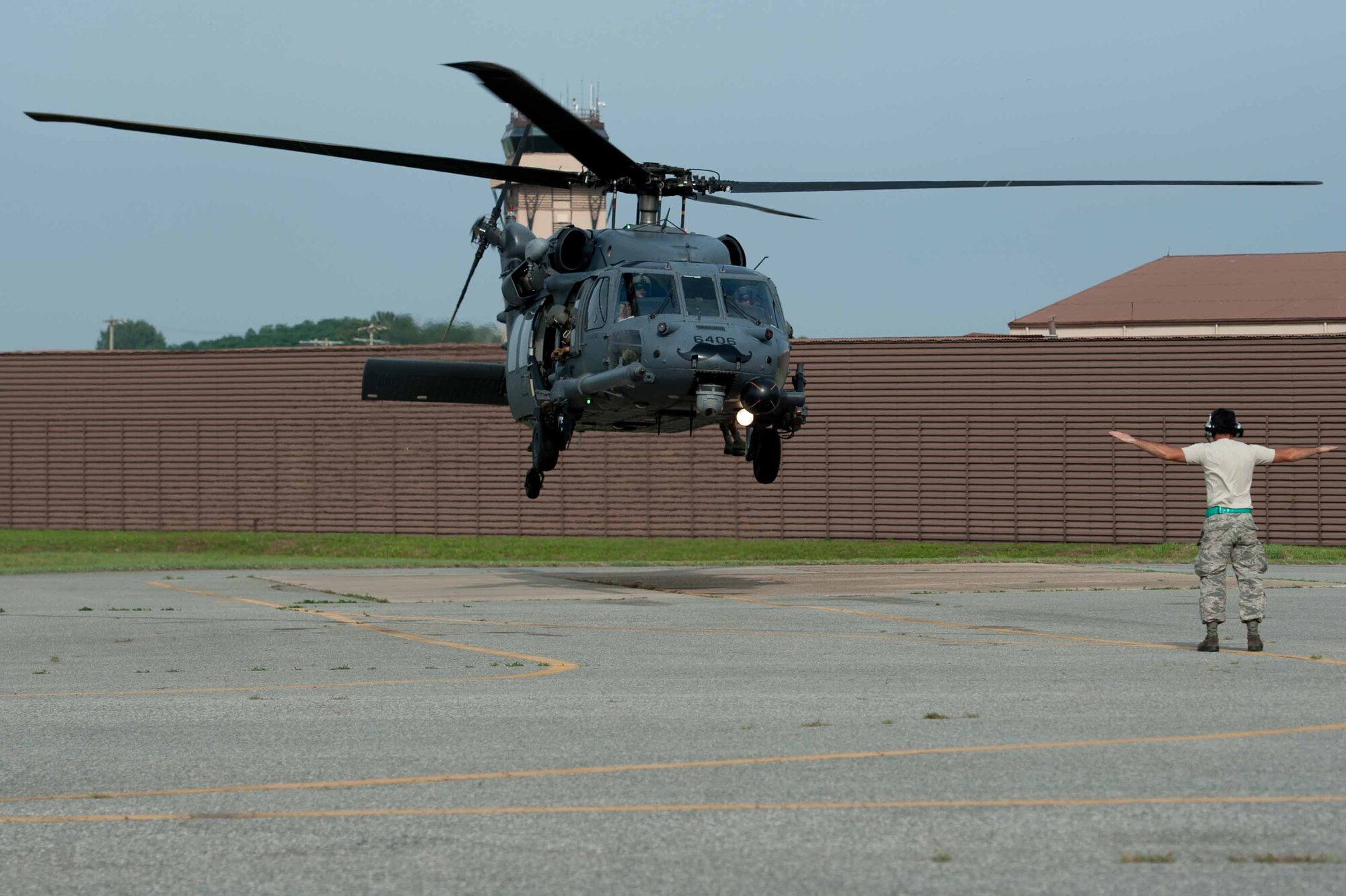 Senior Airman Paul Roberts, 33rd Helicopter Maintenance Unit crew chief, guides in an HH-60G Pave Hawk assigned to 33rd Rescue Squadron after flying a combat search and rescue training scenario for Exercise Pacific Thunder 16-2 at Osan Air Base, Republic of Korea, July 13, 2016. The 33rd RQS plans to test their combat search and rescue skills at Exercise Pacific Thunder 16-01 at Osan. (U.S. Air Force photo by Staff Sgt. Jonathan Steffen/Released) 