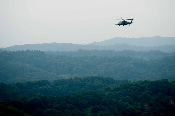 An HH-60G Pave Hawk assigned to 33rd Rescue Squadron flies over Republic of Korea countryside during Exercise Pacific Thunder 16-2, July 13, 2016. The 33d RQS comes to Osan AB, ROK, for Pacific Thunder to train their combat search and rescue capabilities. (U.S. Air Force photo by Staff Sgt. Jonathan Steffen/Released)