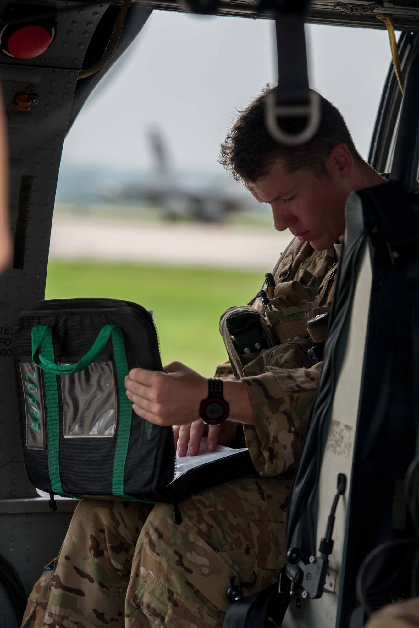 Staff Sgt. Joe Arriza, 33rd Rescue Squadron aerial gunner, looks over a preflight checklist before a combat search and rescue scenario during Exercise Pacific Thunder 16-2 at Osan Air Base, Republic of Korea, July 13, 2016. The 33rd RQS is at Osan to participate in Pacific Thunder, the largest combat search and rescue exercise in the Pacific. (U.S. Air Force photo by Staff Sgt. Jonathan Steffen/Released)