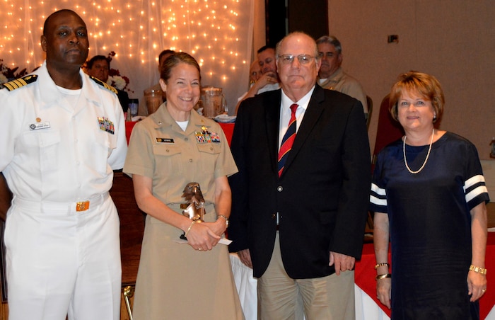 Capt. Robin Lewis, U.S. Public Health Service Corps offer and psychologist serving at Naval Health Clinic Charleston, poses with Capt. Marvin Jones, former commanding officer of NHCC and co-chair of the Federal Executive Association of the Greater Charleston Area, left; Goose Creek Mayor Michael Heitzler; and Glenn Jefferies, chief of corporate communications for the U.S. Army Corps of Engineers, Charleston District and FEA co-chair, after Lewis was presented the 2015 Heroism/Valor Award during the FEA’s Federal Employee of the Year Awards Luncheon May 21, 2015 at the Red Bank Club at Joint Base Charleston – Naval Weapons Station.  (Navy photo/ Kris Patterson)