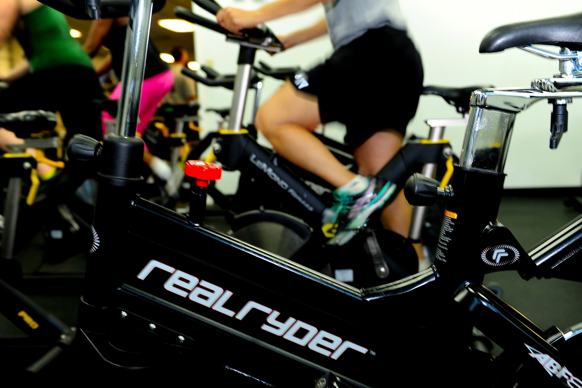 A U.S. Army Soldier adds resistance to her spin bike during a spin class at Anderson Field House at Fort Eustis, Va., July 11, 2016. The spin class aims to intensify cardiovascular activity for people of all fitness levels. (U.S. Air Force photo by Staff Sgt. Natasha Stannard)