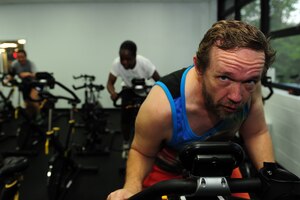 Danny Weatherly, A Company, 1-210th Aviation Regiment, 15Y Apache Armament section instructor, participates in a morning spin class at Anderson Field House at Fort Eustis, Va., July 11, 2016. Weatherly has attended the class regularly since October 2015. (U.S. Air Force photo by Staff Sgt. Natasha Stannard)