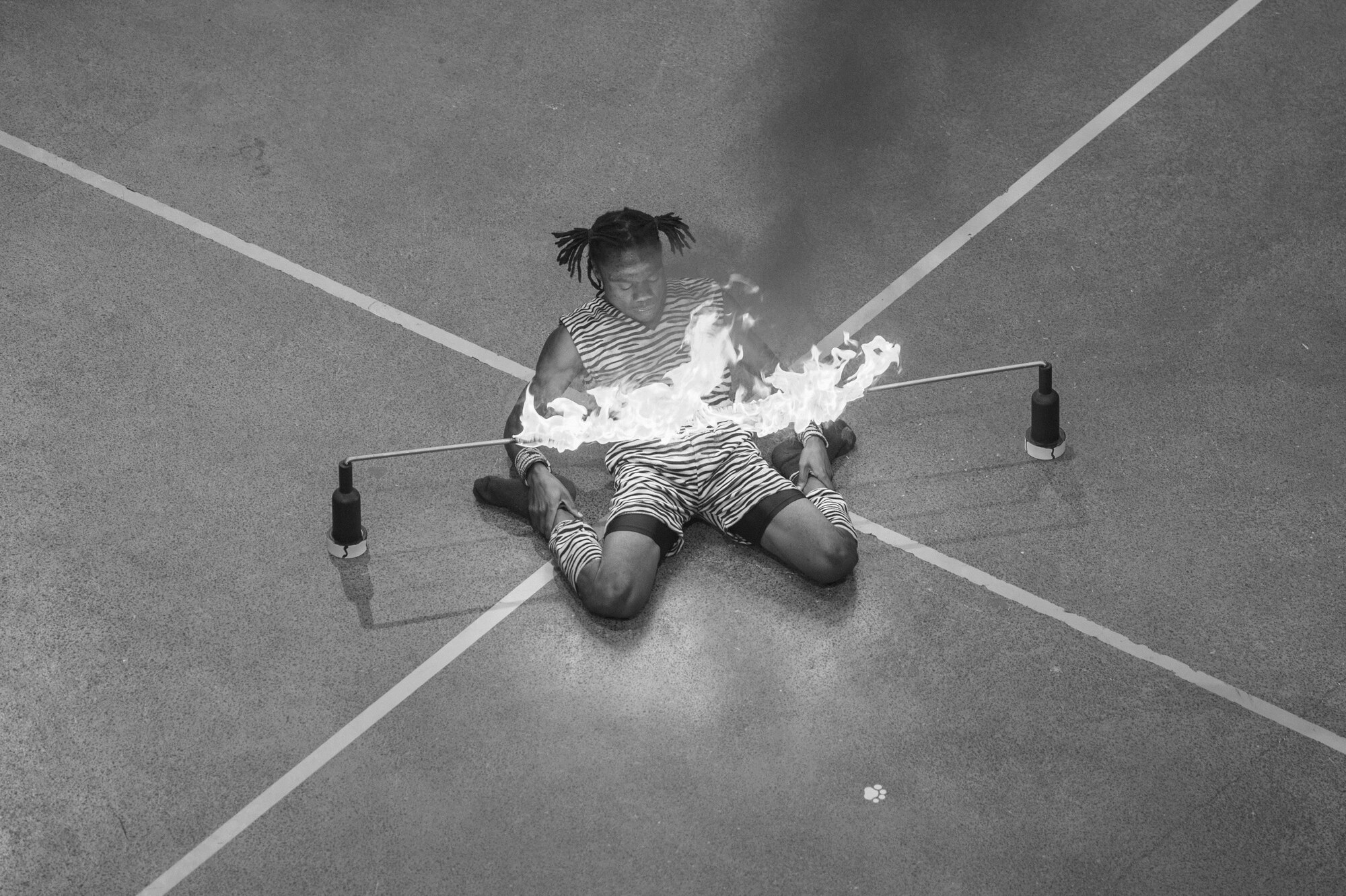 Maddy Vinci, Simba Zambeni Acrobats member, attempts to limbo under a fire during a 2016 Royal Nova Scotia International Tattoo performance at the Scotiabank Centre in Halifax, Nova Scotia, July 3. Coming from Nairobi, Kenya, the acrobats performed a jump rope routine, jumping through hoops, human pyramids and limbo dancing. (U.S. Air Force photo by Senior Airman Ryan J. Sonnier)