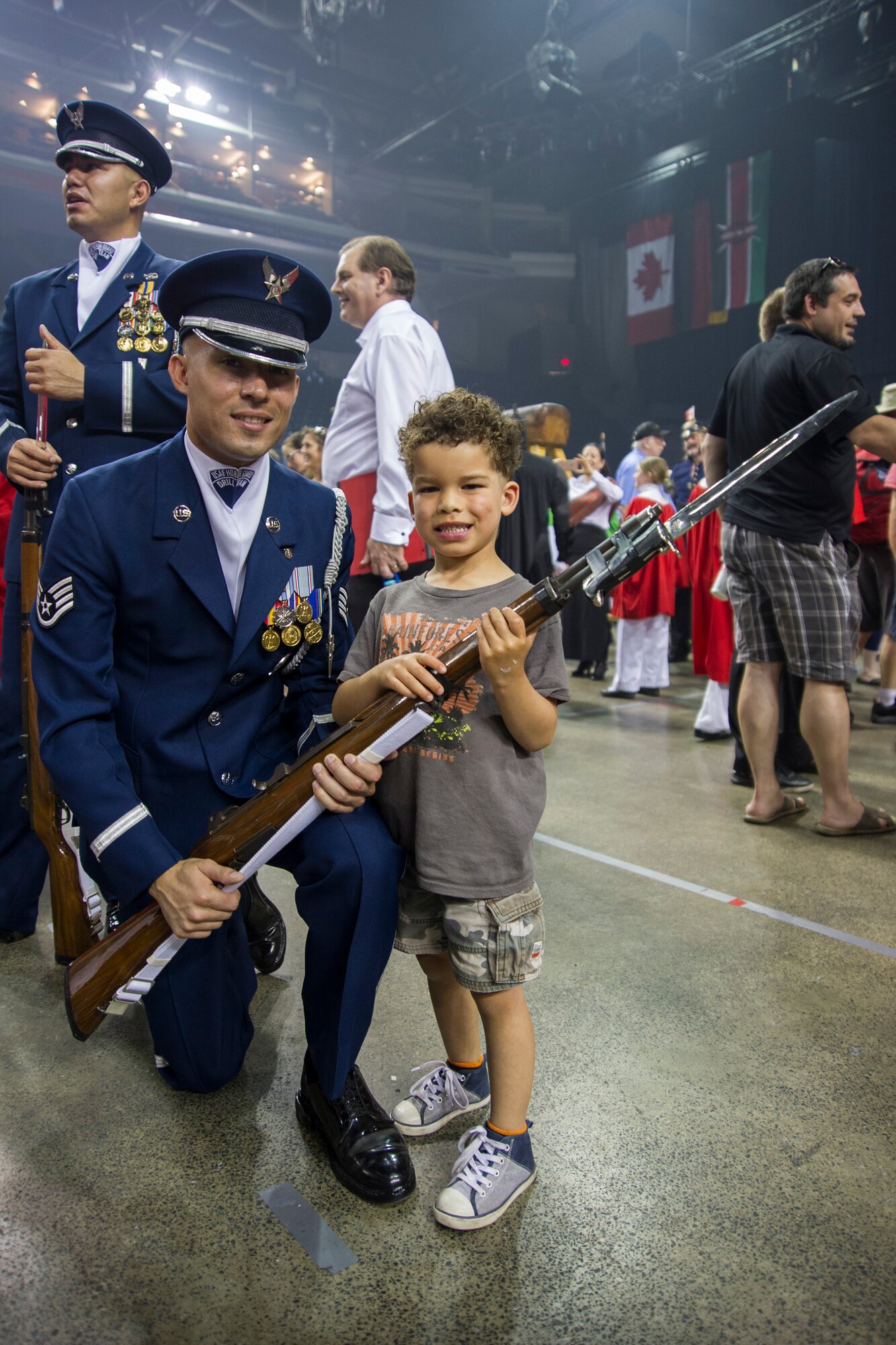 Staff Sgt. Francisco Sanchez, U.S. Air Force Honor Guard Drill Team member, poses for a photo with an audience member after a 2016 Royal Nova Scotia International Tattoo performance at the Scotiabank Centre in Halifax, Nova Scotia, July 1. After every performance, audience members were allowed to interact with the shows performers and take pictures. (U.S. Air Force photo by Senior Airman Ryan J. Sonnier)