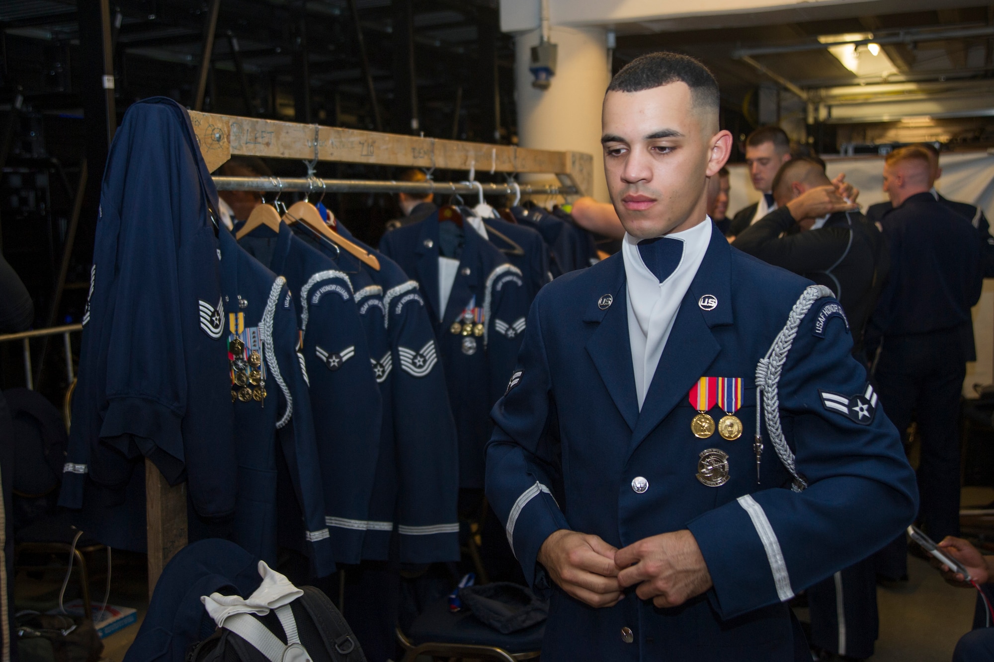 Airman 1st Class Jeremy De Leon, U.S. Air Force Honor Guard Drill Team member, dons his ceremonial blouse before the opening night at the 2016 Royal Nova Scotia International Tattoo at the Scotiabank Centre in Halifax, Nova Scotia, June 30. This was the first time in 20 years that an active duty U.S. Military team has performed at this event. (U.S. Air Force photo by Senior Airman Ryan J. Sonnier)
