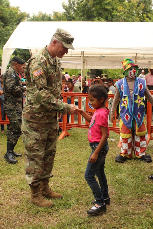 Comayagua, Honduras - U.S. Army Col. Brian Hughes, commander of Joint Task Force-Bravo, shakes hands with one of the children who attended a Medical Partnership Engagement organized by the Experimental Center of Agricultural Development and Ecological Conservation (CEDACE), in San Sebastian, Comayagua, July 9, 2016. JTF-Bravo participated on the MPE at the request of the Director of CEDACE and provided an opportunity to engage with the local community while supporting Honduran military efforts in providing care for the local population. (U.S. Air Force Photo by Capt. David Liapis)