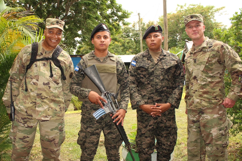 Comayagua, Honduras – U.S. Army Sergeant Major Archie Smith (far left), Joint Task Force-Bravo Medical Element clinical operations, and Sergeant Major Shawn Carns (far right), JTF-Bravo Command Sergeant Major, pose for photo with Honduran Army service members during a Military Partnership Engagement in San Sebastian, Comayagua, Honduras, July 9, 2016.  MPEs provide an opportunity to engage with the community while supporting the Honduran military efforts in providing care for the local population. (U.S. Army photo by Maria Pinel)