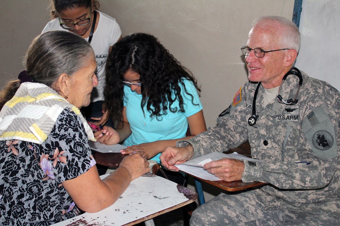 Comayagua, Honduras – U.S. Army Lt. Col. Robert Walkup, Joint Task Force-Bravo Medical Element flight surgeon, listens to a patient during a Military Partnership Engagement between JTF-Bravo and the Experimental Center of Agricultural Development and Ecological Conservation (CEDACE) in San Sebastian, Comayagua, Honduras, July 9, 2016. JTF-Bravo participated in the medical mission at the request of the Military Commander of CEDACE.  (U.S. Army photo by Maria Pinel)