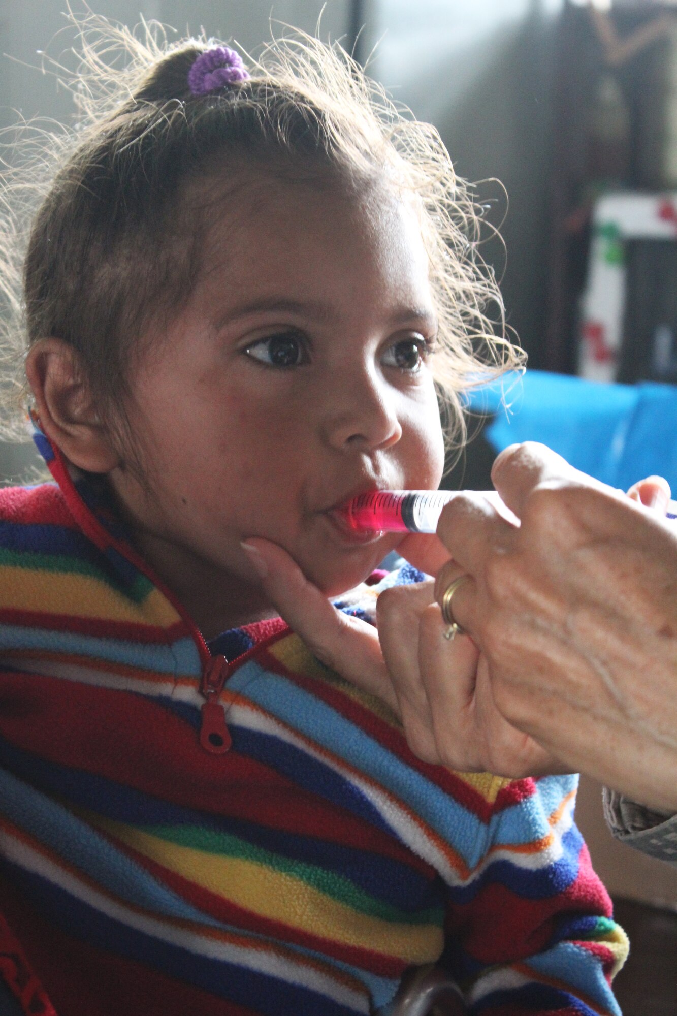 Comayagua, Honduras – A young Honduran girl receives deworming medication from a Joint Task Force-Bravo service member during a Military Partnership Engagement between JTF-Bravo and the Experimental Center of Agricultural Development and Ecological Conservation (CEDACE) in San Sebastian, Comayagua, Honduras, July 9, 2016. MPEs are one way JTF-Bravo demonstrates its commitment to supporting partner nation efforts in providing humanitarian assistance to their people. 