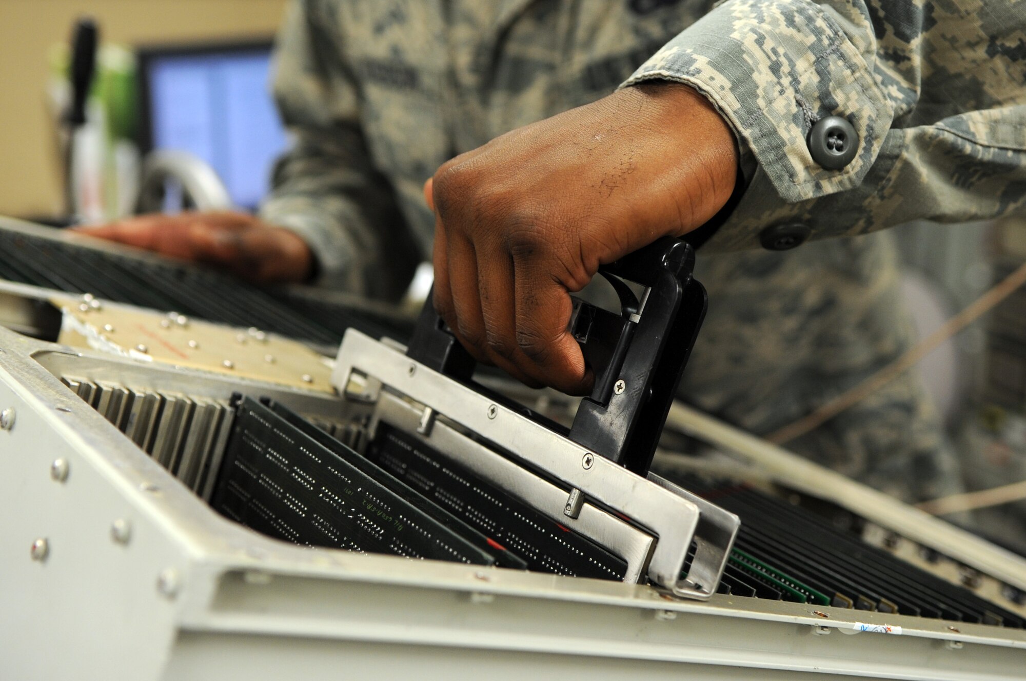 U.S. Air Force Senior Airman George Dickerson, 7th Component Maintenance Squadron avionics journeyman, pulls a circuit card from a radar jammer June 21, 2016, at Dyess Air Force Base, Texas. The removal of the circuit card is required to troubleshoot the radar jammer, which is used to safeguard the B-1B Lancer. Completing this task is one of the internal goals set by the 7th CMS avionics back shop to ensure the supply levels of the B-1 fleet are strong. (U.S. Air Force photo by Senior Airman Kedesha Pennant/Released)

