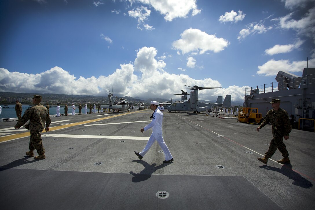 U.S. Marines and sailors march to their designated saluting position minutes before USS America leaves port July 12, 2016. III Marine Expeditionary Forces will conduct mission rehearsals of landing force integration with an amphibious task force during Rim of the Pacific 2016. Twenty-six nations, 49 ships, six submarines, about 200 aircrafts, and 25,000 personnel are participating in RIMPAC 2016 from June 29 to Aug. 4 in and around the Hawaiian Islands and Southern California. The world’s largest international maritime exercise, RIMPAC provides a unique training opportunity while fostering and sustaining cooperative relationships between participants critical to ensuring the safety of sea lanes and security on the world’s oceans. 