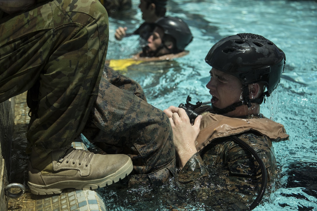 U.S. Marine Lance Cpl. Gregory Abranson practices breathing underwater upside down with a breathing device July 6, 2016. U.S. Marines and Australian soldiers conducted shallow water egress training in preparation of mission rehearsals of landing force integration with an amphibious task force during Rim of the Pacific 2016. RIMPAC is the world's largest international maritime exercise, and provides a unique training opportunity that helps participants foster and sustain cooperative relationships that are critical to ensuring the safety of sea lanes and security on the world's oceans. RIMPAC 2016 is the 25th exercise in the series that began in 1971.