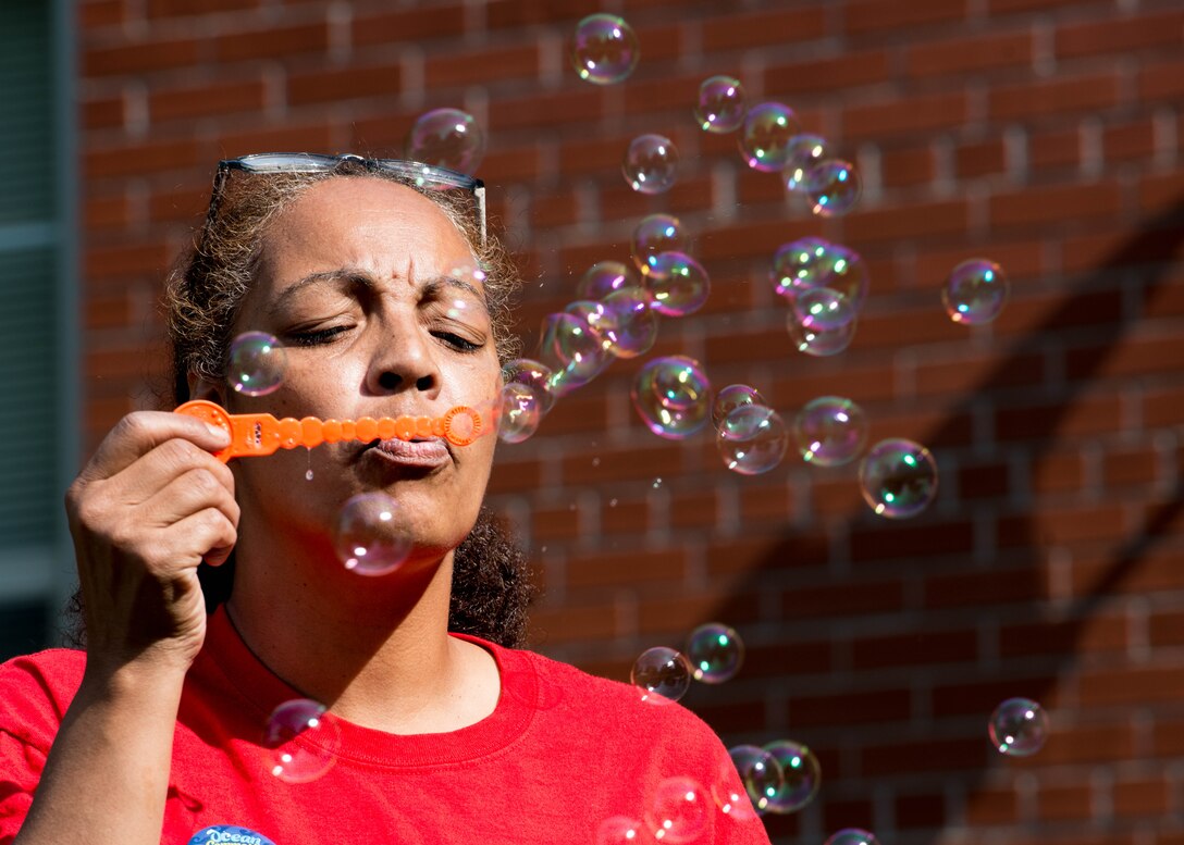 Ms. Juana Hennessey, Vacation Bible School instructor, blows bubbles for her Vacation Bible School students at Fort Eustis, Va., July 12, 2016. Fort Eustis' Regimental Memorial Chapel hosts programs such as the annual Vacation Bible School for service members and their families, to help them through challenges that can come with military service. (U.S. Air Force photo by Staff J.D. Strong II)