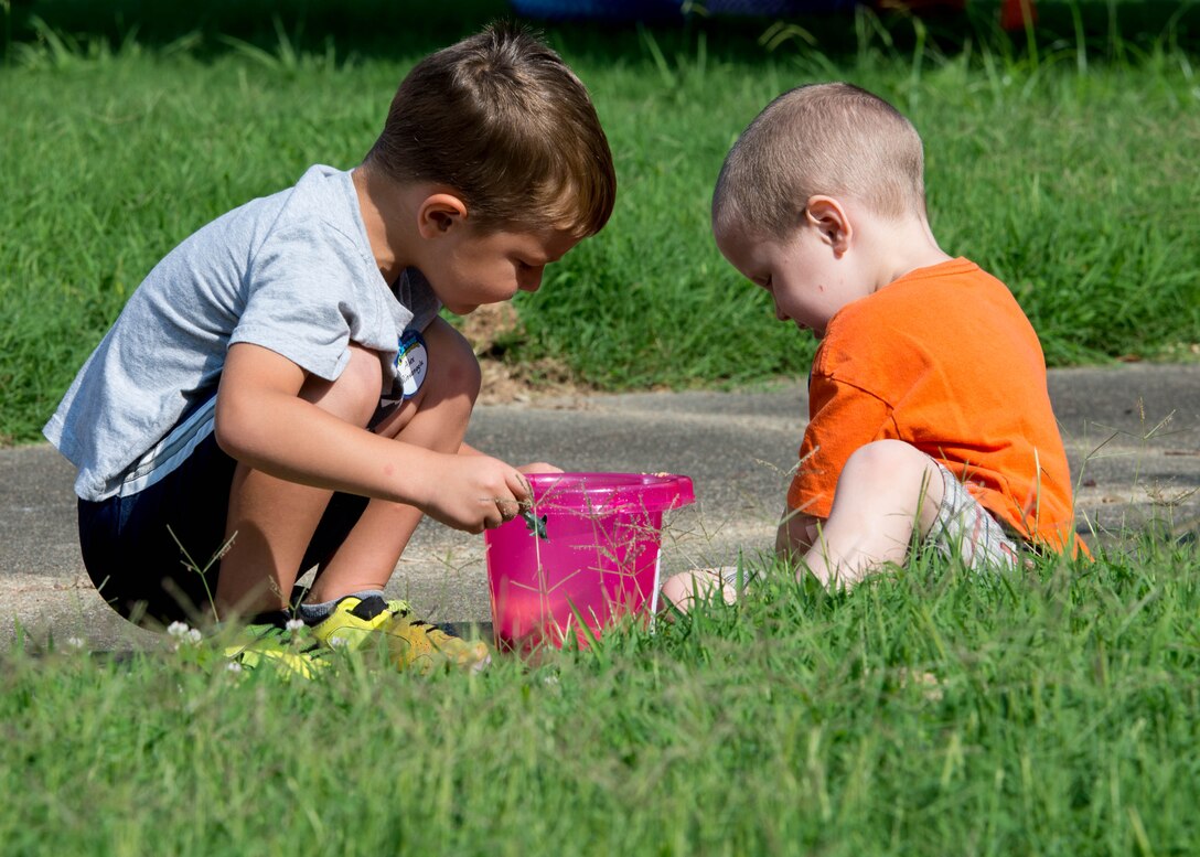 Two children play outside during Vacation Bible School at Fort Eustis, Va., July 12, 2016. Vacation Bible School is open to children in grades kindergarten through fifth grade. (U.S. Air Force photo by Staff J.D. Strong II)