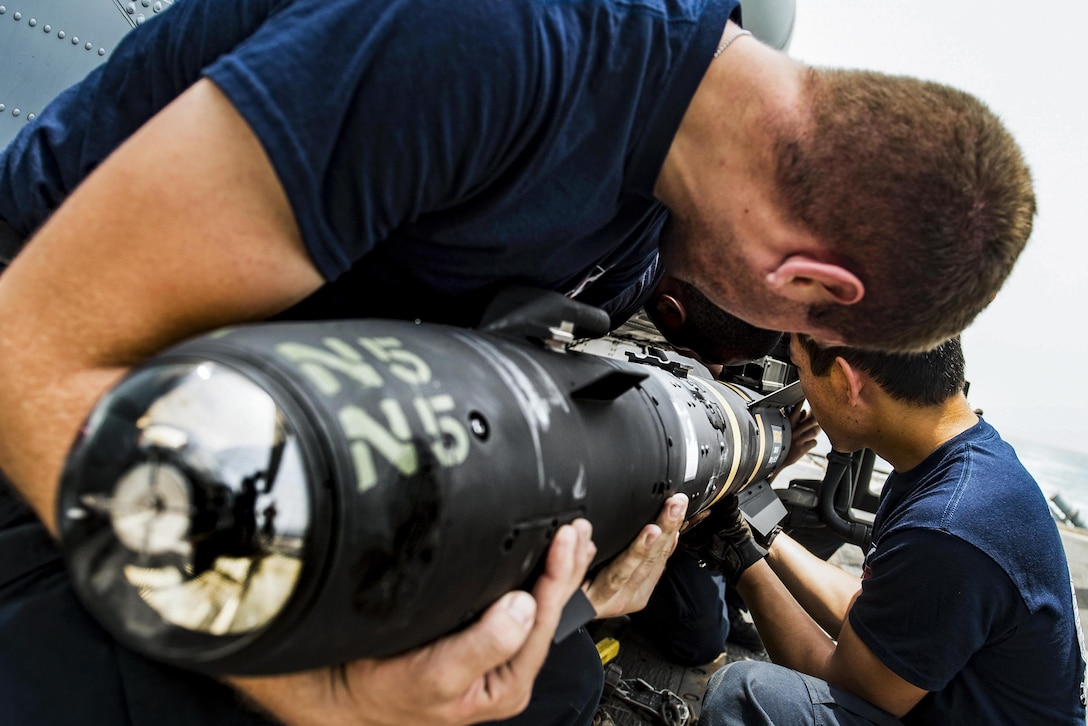 Sailors load an AGM-114 Hellfire missile onto an MH-60R Seahawk helicopter on the USS San Jacinto in the Strait of Bab-el-Mandeb, July 12, 2016. The guided-missile cruiser is supporting maritime security operations in the U.S. 5th Fleet area of operations. Navy photo by Petty Officer 3rd Class J. Alexander Delgado