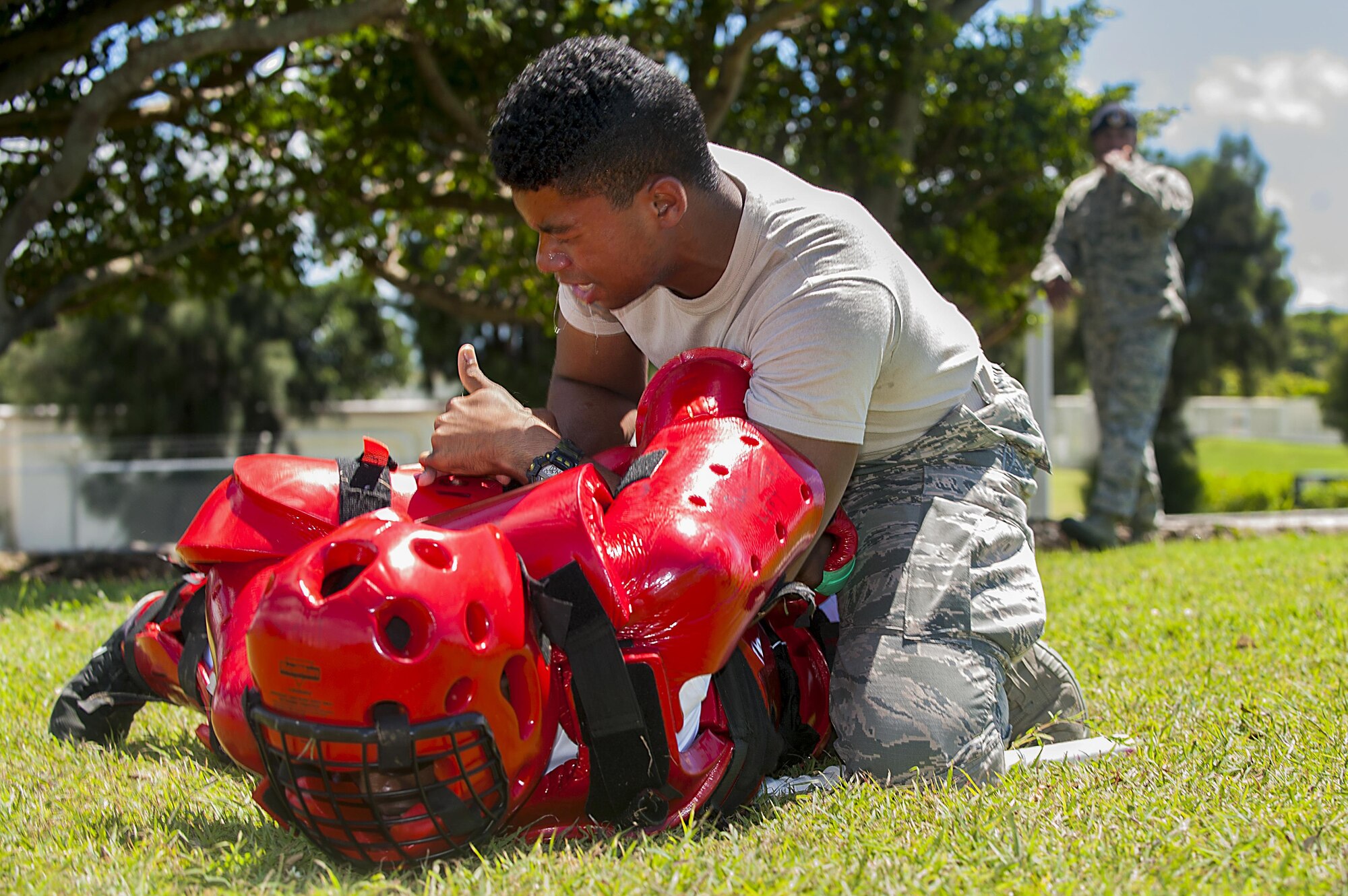 U.S. Air Force Airman 1st Class Zahn Hicks, 18th Security Forces Squadron response force member, takes down an attacker in a red-man suit after being sprayed in the eyes with OC spray during training July 13, 2016, at Kadena Air Base, Japan. Security forces member have to be ready for any situation, including being sprayed with OC spray and still having to fight back and subdue an attacker. (U.S. Air Force photo by Airman 1st Class Corey M. Pettis)