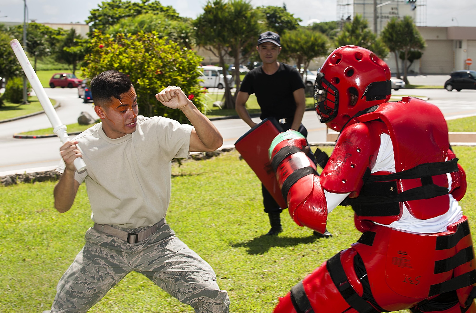 U.S. Air Force Airman Joshua Lenaire, 18th Security Forces Squadron response force member, uses a training baton to subdue an attacker in a red-man suit after being sprayed with OC spray during training July 13, 2016, at Kadena Air Base, Japan. Every SFS member must train to use OC spray by getting sprayed and completing an obstacle course. (U.S. Air Force photo by Airman 1st Class Corey M. Pettis)