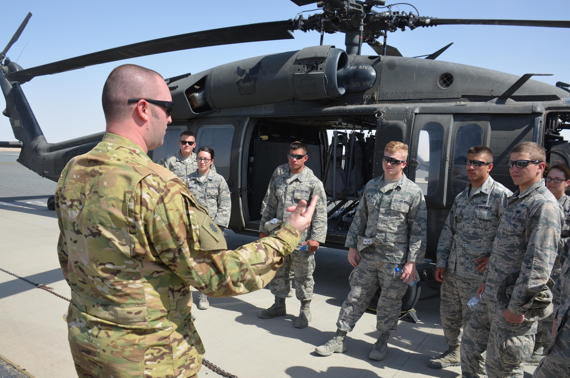 A U.S. Army UH-60 Blackhawk pilot briefs Air Force Academy cadets on the aircraft's capabilities, July 7, at a Southwest Asia Army base. (US Air Force photo by Master Sgt. Andrew Biscoe)