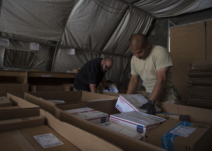 Staff Sgt. Tony Tran, 455th Expeditionary Communications Squadron knowledge management craftsman, lifts a package, July 13, 2016, Bagram Airfield, Afghanistan. Airmen from the 455th ECS distribute packages so designated mail orderlies can pick them up for their units. (U.S. Air Force photo by Senior Airman Justyn M. Freeman)