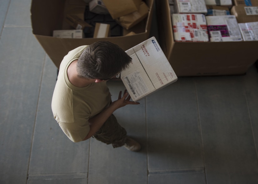 Senior Airman Christopher Collins, 455th Expeditionary Communications Squadron knowledge management craftsman, looks at a shipping address, July 13, 2016, Bagram Airfield, Afghanistan. Members of the 455th ECS knowledge management flight help with the postal additional duty. The task includes receiving, organizing, and distributing mail to the organizations throughout the base. (U.S. Air Force photo by Senior Airman Justyn M. Freeman)