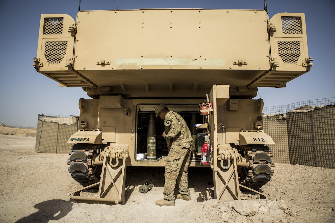 A soldier helps resupply artillery rounds for an M109A6 Paladin howitzer with artillery rounds after a fire mission at Al-Taqaddum Air Base, Iraq, June 27, 2016, to support Operation Inherent Resolve. Marine Corps photo by Sgt. Donald Holbert