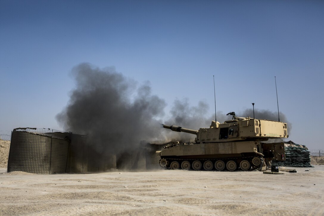 Soldiers fire an M109A6 Paladin howitzer during a fire mission at Al-Taqaddum Air Base, Iraq, June 27, 2016, to support Operation Inherent Resolve. Marine Corps photo by Sgt. Donald Holbert