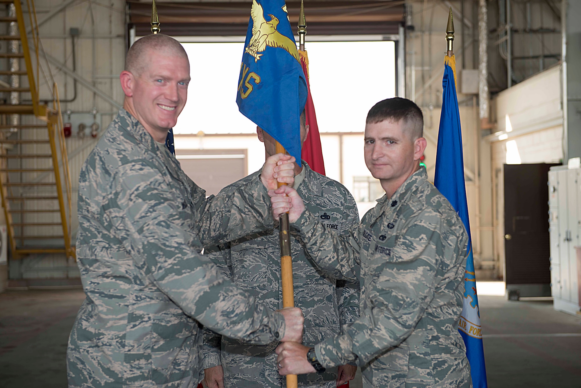 U.S. Air Force Lt. Col. Shad Colgate, 39th Maintenance Squadron incoming commander receives the guidon from Col. John Walker, 39th Air Base Wing commander, during an assumption of command ceremony July 14, 2016, at Incirlik Air Base, Turkey. Prior to taking command here, Colgate served as the Joint Munitions Officer for U.S. European Command in Stuttgart, Germany. (U.S. Air Force photo by Airman 1st Class Devin M. Rumbaugh)