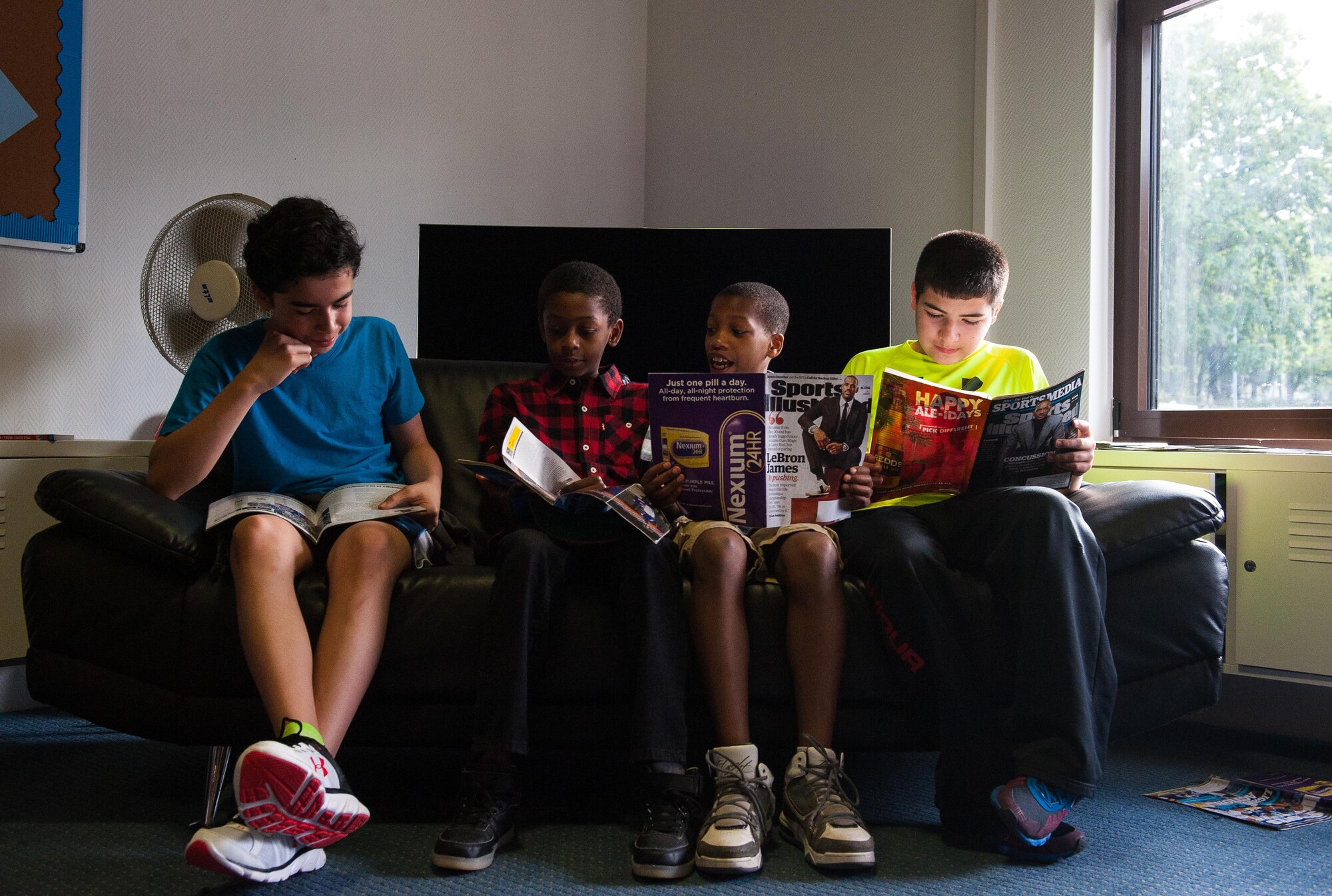 A group of kids read magazines together as they participate in a Science, Technology, Engineering and Mathematics youth camp July 11, 2016, at Ramstein Air Base, Germany. The camp is part of an initiative at Ramstein to further develop children in key areas that will benefit them throughout their life. 