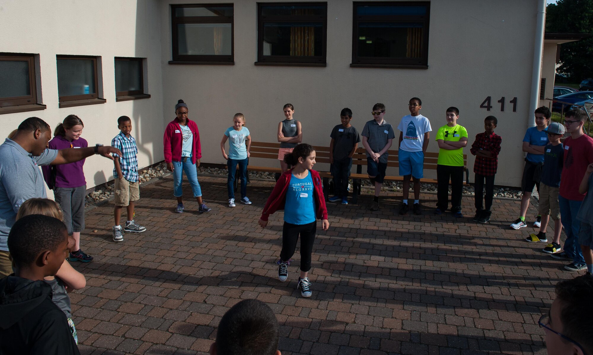 A child participates in “Bumpity bump bump,” a game that is designed to help its participants get to know each other, during a Science, Technology, Engineering and Mathematics youth camp July 11, 2016, at Ramstein Air Base, Germany. The game’s premise is to have kids learn the name of the peer next to them in the circle, and if they can’t remember it in time, they must be in the middle. This was one of several activities the children took part in the beginning of the youth camp to get familiar with one another.