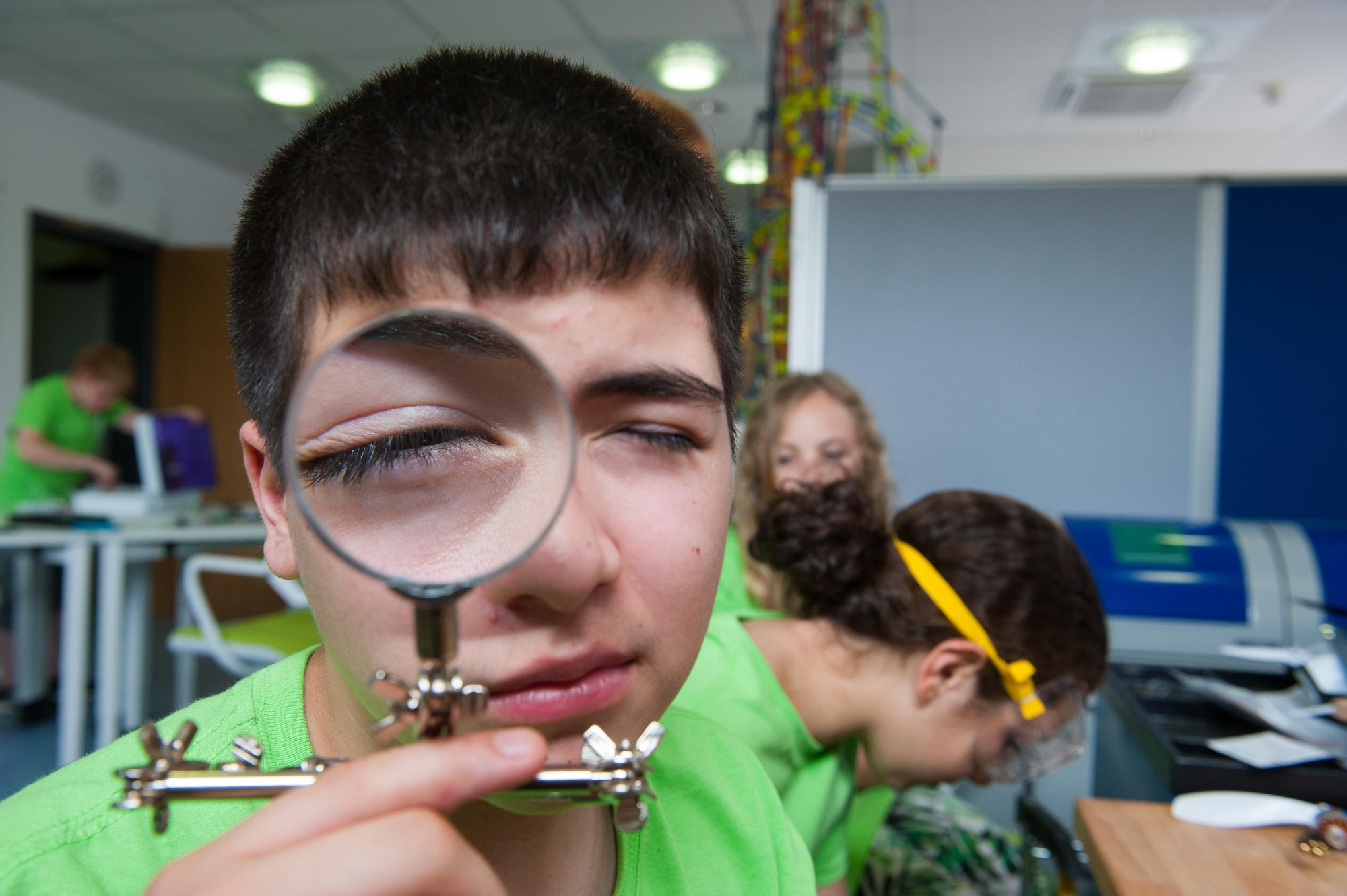 Gavin Manriquez, Spangdahlem Air Base middle school student, looks through a magnifying glass as he participates in a Science, Technology, Engineering and Mathematics youth camp July 12, 2016, at Ramstein Air Base, Germany.  The youth camp encourages children of all ages to show off their creative sides by taking part in dozens of activities throughout the week that teach them essential skills, such as constructing, coding programs on a computer and more.