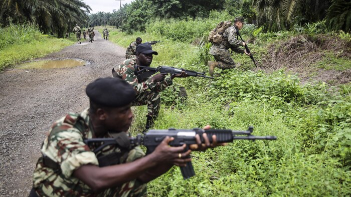 Cpl. Mitchell York, a rifleman with Special Purpose Marine Air-Ground Task Force Crisis Response-Africa, rushes forward during a simulated contact left attack during a patrolling exercise with Cameroonian soldiers with Forces Fusiliers Marins et Palmeurs de Combat in Limbé, Cameroon, June 28, 2016.  Marines share tactics, techniques and skills with the FORFUMAPCO soldiers to combat the illicit trafficking in Cameroon. 