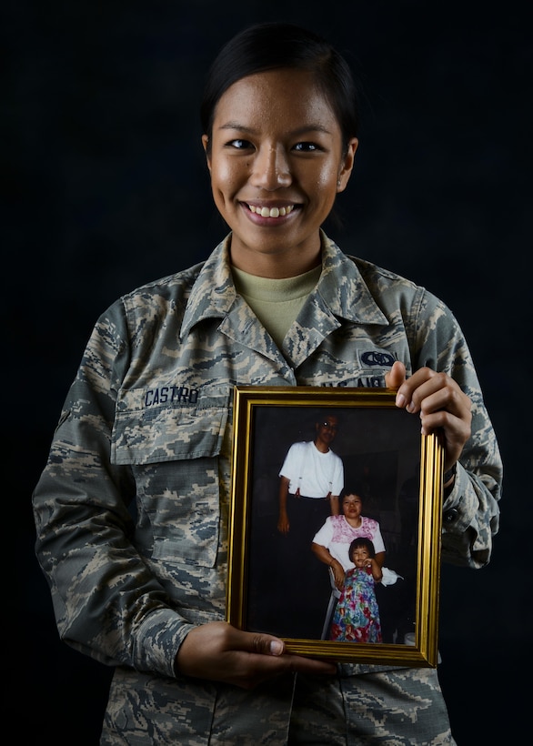Airman Abi Castro, 31st Operations Support Squadron airfield management apprentice, holds a picture of her and her parents, July 12, 2016, at Aviano Air Base, Italy. Castro was born in the Philippines and she said she serves today to give back to those who have enabled her to succeed. (U.S. Air Force photo by Senior Airman Austin Harvill/Released)
