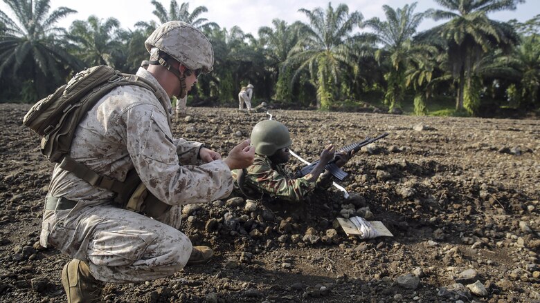 Cpl. Jeremy Osteen, a squad leader with Special Purpose Marine Air-Ground Task Force Crisis Response-Africa, shows a Cameroonian soldier with Forces Fusiliers Marins et Palmeurs de Combat an immediate action drill for his weapon while on the range in Limbé, Cameroon, July 1, 2016.  Marines share tactics, techniques and skills with the FORFUMAPCO soldiers to combat the illicit trafficking in Cameroon. 
