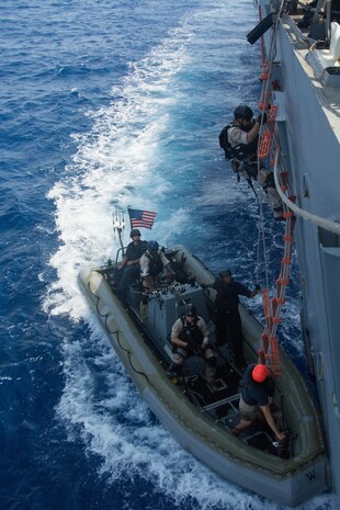 (July 01, 2016) Sonar Technician 2nd Class Charles Granger, top right, climbs down the pilot’s ladder to a rigid hull inflatable boat as a member of the visit, board, search and seizure team during a simulated Maritime Interdiction Operation aboard the Arleigh Burke-class guided-missile destroyer USS Mason (DDG 87). Mason, deployed as part of the Eisenhower Carrier Strike Group, is supporting maritime security operations and theater security cooperation efforts in the U.S. 5th Fleet area of operations. 
