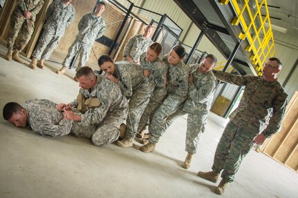 U.S. Marine Corps Gunnery Sgt. Timothy Hanson, Marine Corps Installations East Regional Brig, Camp Lejeune, Jacksonville, North Carolina, instructs U.S. Army Soldiers from the 79th Military Police Company on detainee extraction procedures during Warrior Exercise (WAREX) 86-16-03 at Fort McCoy, Wis., July 12, 2016. WAREX is designed to keep soldiers all across the United States ready to deploy.
(U.S. Army photo by Spc. John Russell/Released)