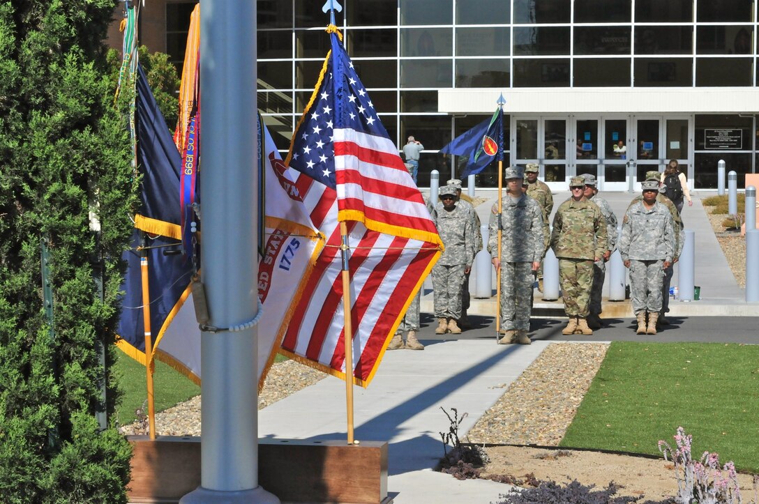 A distant breeze gently blows the U.S. flag as Soldiers from Headquarters and Headquarters Company, 63rd Regional Support Command, stand at attention following a change of command ceremony, July 13, at the Armed Forces Reserve Center, Mountain View, California.