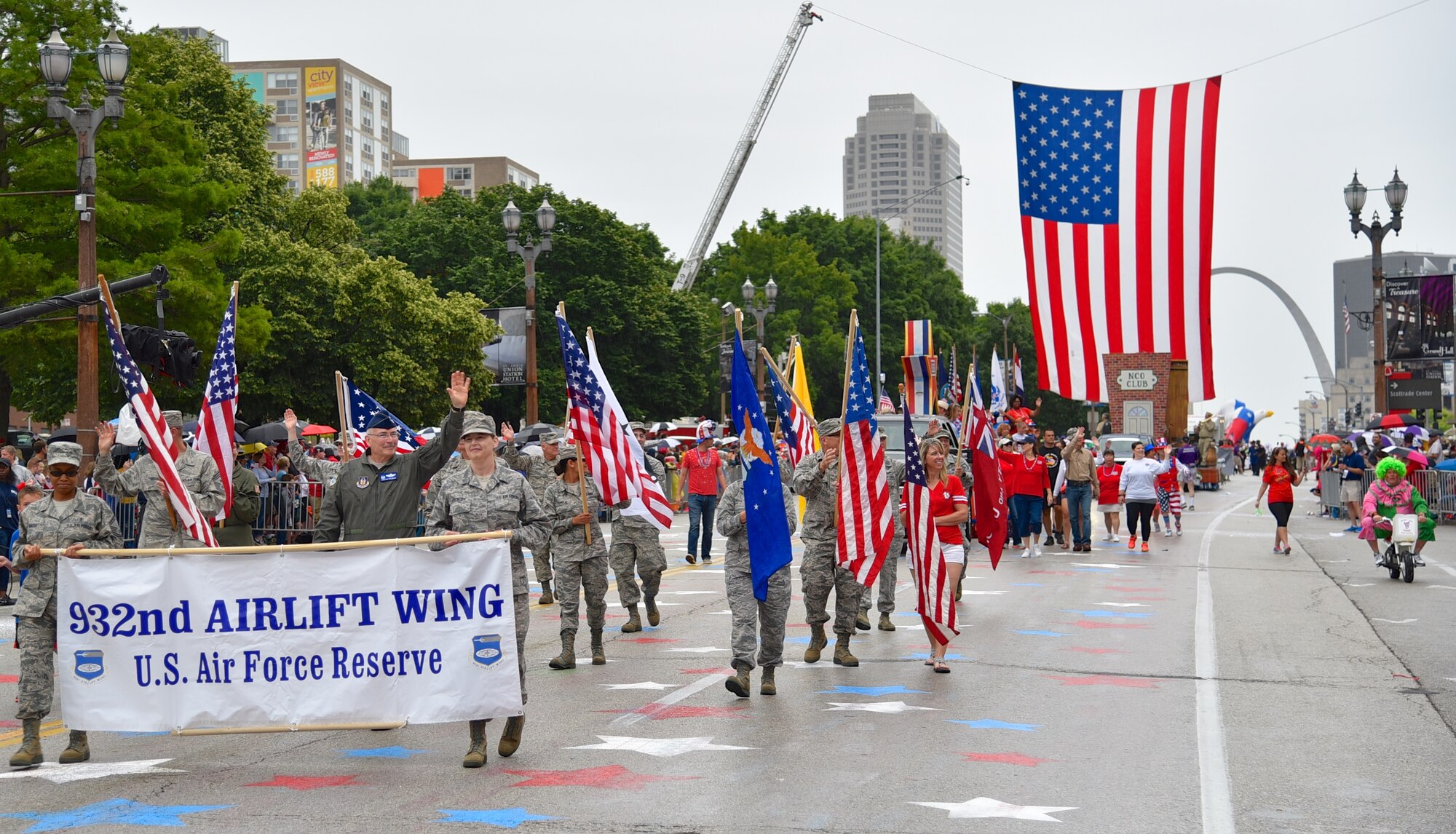 Commander of the 932nd Airlift Wing, Col. Jonathan Philebaum (center, waving), led his wing volunteers on a 1.5 mile walk in the Saint Louis Independence Day "VP" parade on July 2, 2016. The unit located at Scott Air Force Base, flies the C-40C aircraft for distinguished visitor airlift. (U.S. Air Force photo by Tech. Sgt. Christopher Parr)