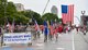 Commander of the 932nd Airlift Wing, Col. Jonathan Philebaum (center, waving), led his wing volunteers on a 1.5 mile walk in the Saint Louis Independence Day 