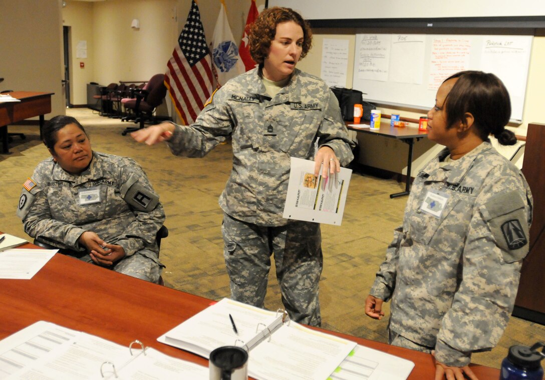 FORT MCCOY, Wisconsin (July 13, 2016) – Sgt. 1st Class Uraina McNally, (center) a member of the 312th Army Band, 88th Regional Support Command, leads a group discussion during the Sexual Harassment/Assault Response and Prevention foundation course currently being taught at the 88th RSC headquarters on Fort McCoy, Wisconsin, July 13. The course prepares Soldiers to teach SHARP classes at the unit level. Additionally, this SHARP foundation course is two-weeks long and serves as the initial training if a Soldier wants to become a unit victim advocate or a sexual assault response coordinator. After successfully completing this course, Soldiers will then need to be certified by the National Organization for Victim Assistance in order to serve as a VA or SARC.