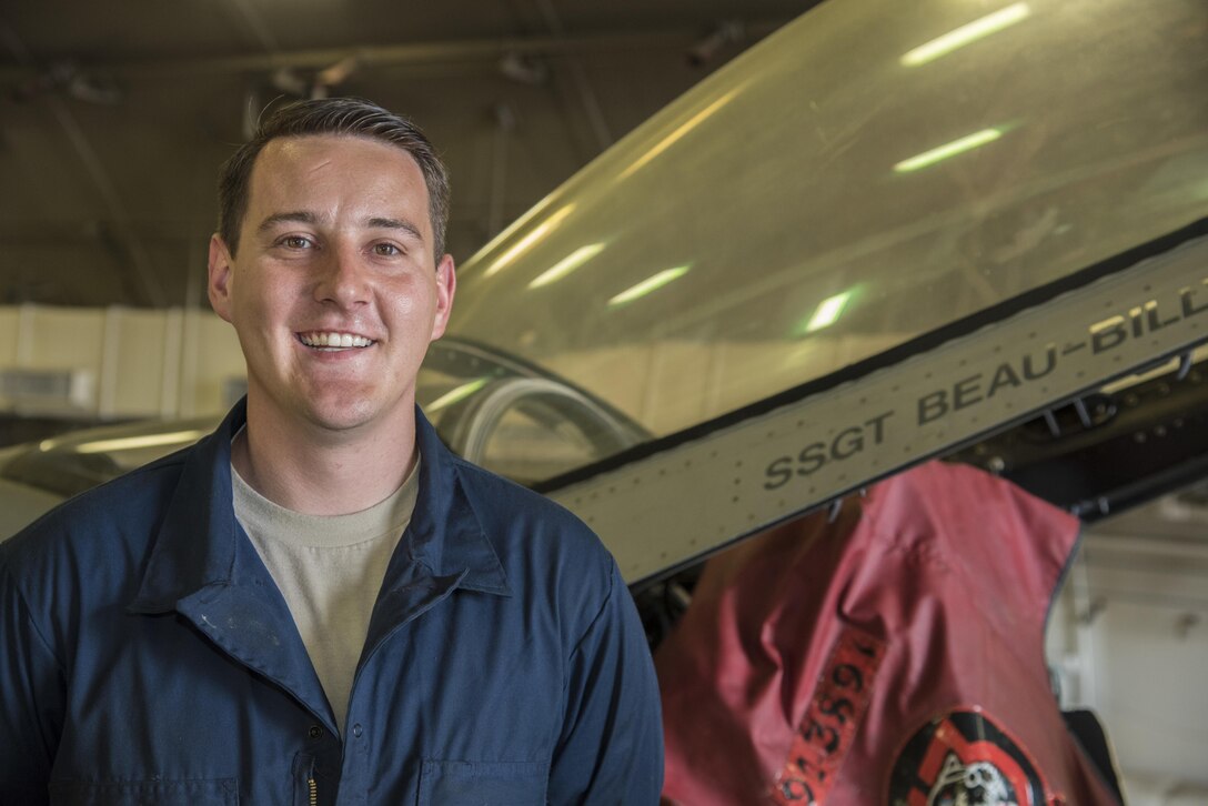 Air Force Staff Sgt. Beau Blackburn, a dedicated crew chief with the 35th Aircraft Maintenance Squadron, poses for a photograph next to an F-16 Fighting Falcon canopy at Misawa Air Base, Japan, June 16, 2016. When a crew chief is assigned to an aircraft, their name is printed below the bubble canopy. This tradition signifies the responsibility each crew chief has to keep their aircraft in perfect working order, ensuring its reliability. Air Force photo by Airman 1st Class Jordyn Fetter