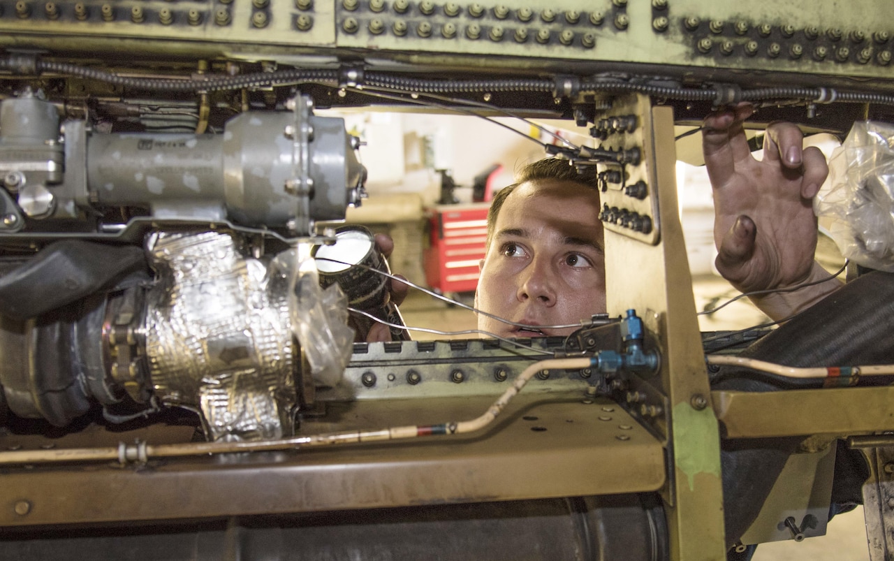 Air Force Staff Sgt. Beau Blackburn, a dedicated crew chief with the 35th Aircraft Maintenance Squadron, shines a flashlight into an F-16 Fighting Falcon at Misawa Air Base, Japan, June 16, 2016. Visual inspections help aircraft maintainers discover damage. Blackburn is from Iona, Idaho. Air Force photo by Airman 1st Class Jordyn Fetter